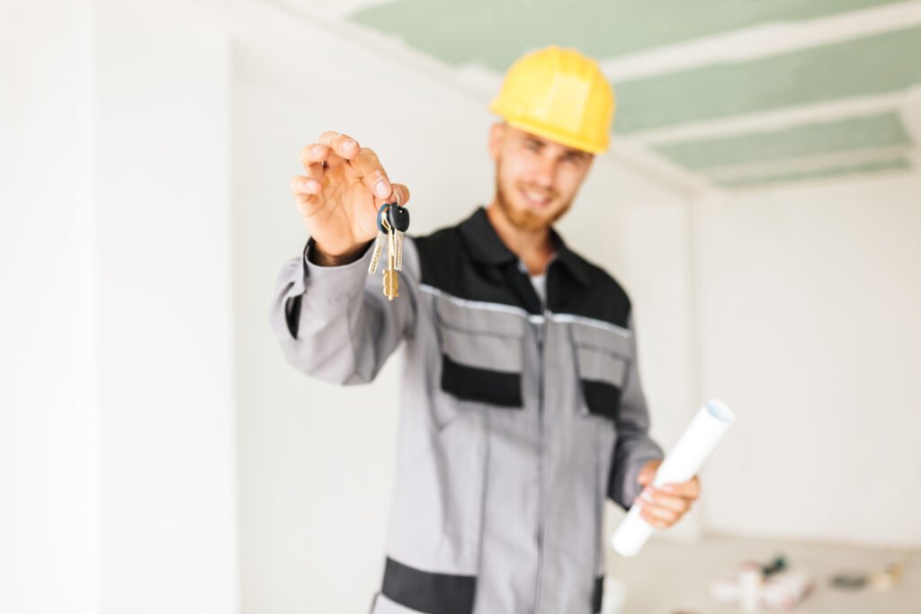 close up photo of young engineer in work clothes and yellow hard